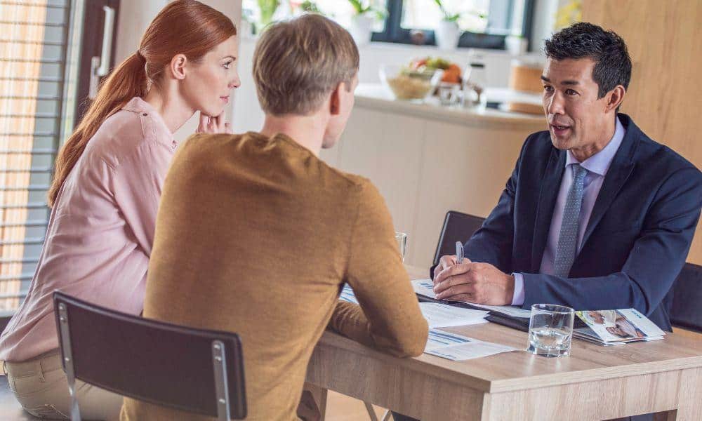Insurance agent talking with couple about insurance services