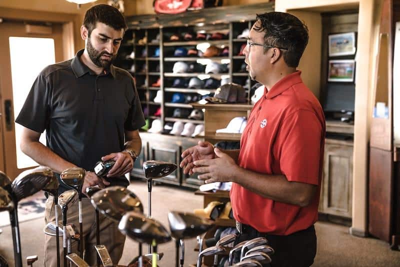 small business owner talking to a customer at their retail shop