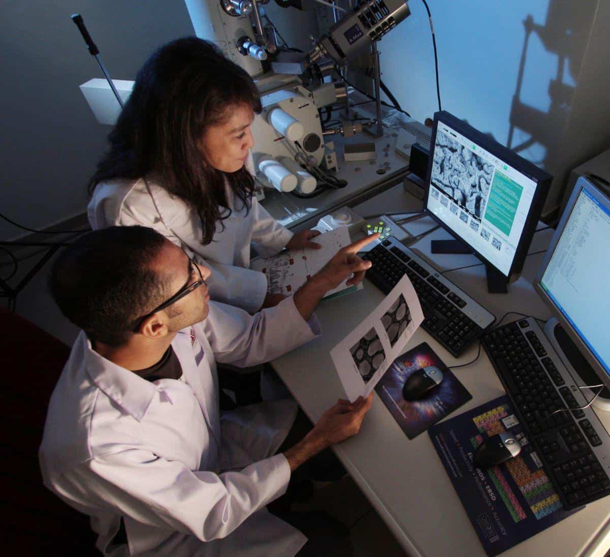 two biotech workers developing a new product that needs insurance coverage